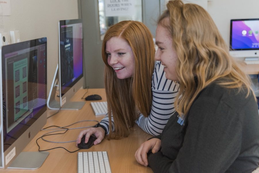 Bigfork High School Editor-in-Chief senior Liz Hyde meets with freshman Anna Hocevar to modify and polish an infographic for the March-April edition of The Norse Code.